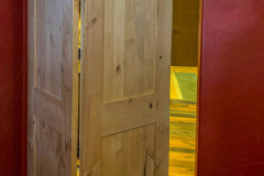 Barnfold hardware on unfinished wood door