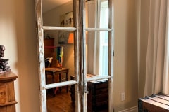 Reclaimed, antique French doors  mounted with hidden roller barn door hardware