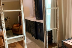 Reclaimed, antique French doors  mounted with hidden roller barn door hardware