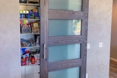 Hidden roller hardware on a custom-made sliding pantry door