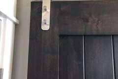 Stainless Steel Series hardware on dark wood barn door