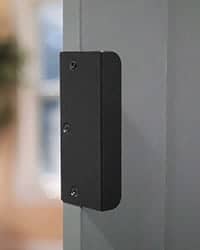 edge pull door handle mounted on gray door